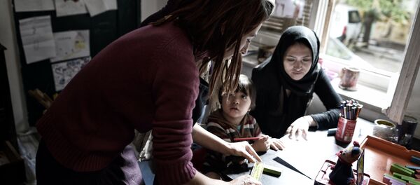 A greek squatter teaches at a school at the prosfygika complex in central Athens (File) A greek squatter teaches at a school at the prosfygika complex in central Athens (File) - Sputnik International