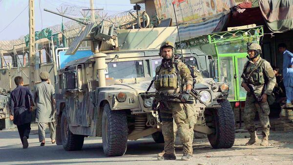 Afghan security forces keep watch in front of their armoured vehicle in Kunduz city, Afghanistan October 4, 2016 - Sputnik International