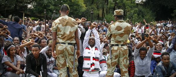 In this photo taken on Sunday, Oct. 2, 2016, Ethiopian soldiers try to stop protesters in Bishoftu, Ethiopia In this photo taken on Sunday, Oct. 2, 2016, Ethiopian soldiers try to stop protesters in Bishoftu, Ethiopia - Sputnik International