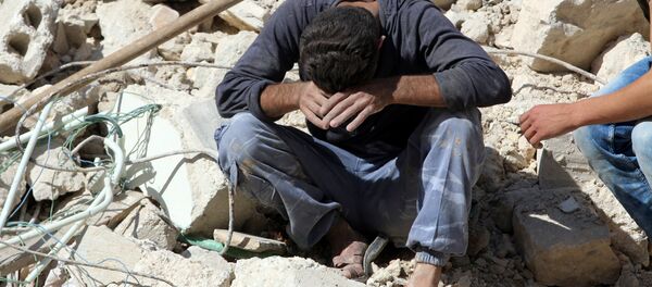 A man reacts on the rubble of damaged buildings after losing relatives to an airstrike in the besieged rebel-held al-Qaterji neighbourhood of Aleppo, Syria October 11, 2016. A man reacts on the rubble of damaged buildings after losing relatives to an airstrike in the besieged rebel-held al-Qaterji neighbourhood of Aleppo, Syria October 11, 2016. - Sputnik International