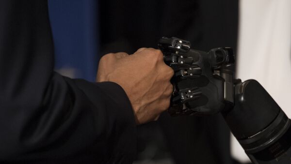 US President Barack Obama (L) fist bumps with the robotic arm of neuro interface patient Nathan Copeland (R) as he tours innovation projects at the White House Frontiers Conference at the University of Pittsburg in Pittsburg, PA, October 13, 2016. - Sputnik International
