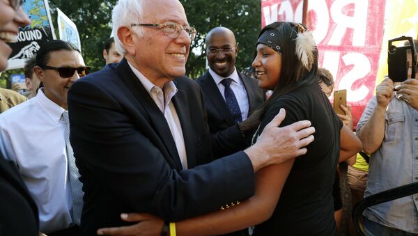 Sen. Bernie Sanders, I-Vt., left, greets Jasilyn Charger, a member of the Cheyenne River Sioux Tribal Youth Council, after Charger spoke to a group of supporters of the Standing Rock Sioux Tribe who were rallying in opposition of the Dakota Access oil pipeline, during a rally by the White House, Tuesday, Sept. 13, 2016, in Washington. Sanders also spoke at the rally. - Sputnik International