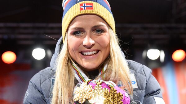 This file photo taken on February 28, 2015 shows Norway's Therese Johaug celebrating with her three gold medals during the medals ceremony of the women's cross country 30 km mass start classic style competition of the 2015 FIS Nordic World Ski Championships in Falun, Sweden. - Sputnik International