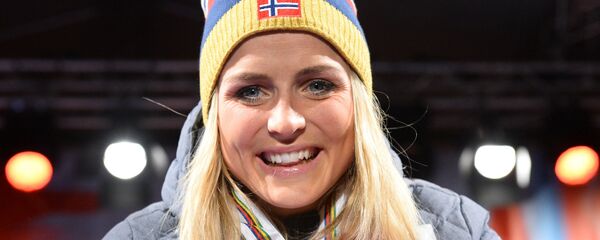 This file photo taken on February 28, 2015 shows Norway's Therese Johaug celebrating with her three gold medals during the medals ceremony of the women's cross country 30 km mass start classic style competition of the 2015 FIS Nordic World Ski Championships in Falun, Sweden. This file photo taken on February 28, 2015 shows Norway's Therese Johaug celebrating with her three gold medals during the medals ceremony of the women's cross country 30 km mass start classic style competition of the 2015 FIS Nordic World Ski Championships in Falun, Sweden. - Sputnik International
