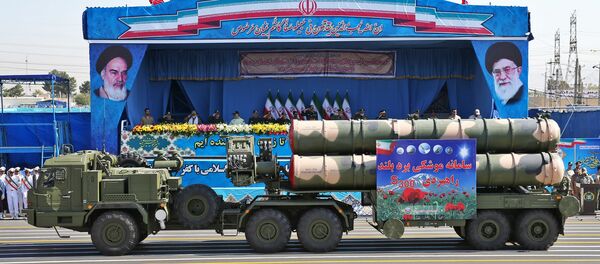 In front of the portraits of supreme leader Ayatollah Ali Khamenei, right, and late revolutionary founder Ayatollah Khomeini, left, a long-range, S-300 missile system is displayed by Iran's army during a military parade marking the 36th anniversary of Iraq's 1980 invasion of Iran, in front of the shrine of late revolutionary founder Ayatollah Khomeini, just outside Tehran, Iran, Wednesday, Sept. 21, 2016 - Sputnik International
