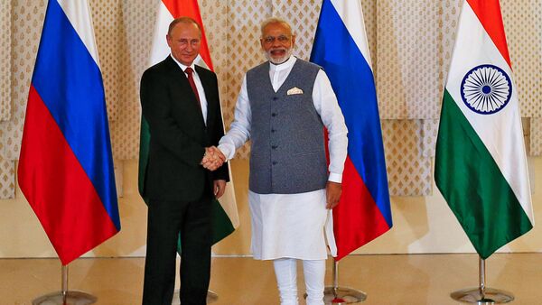 Russian President Vladimir Putin (L) shakes hand with India's Prime Minister Narendra Modi during a photo opportunity ahead of India-Russia Annual Summit in Benaulim, in the western state of Goa, India, October 15, 2016 - Sputnik International