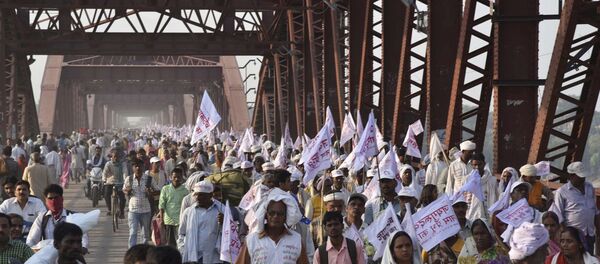 Hindu pilgrims hold religious flags and walk on a crowded bridge after a stampede on the same bridge on the outskirts of Varanasi, India, Saturday, Oct. 15, 2016 Hindu pilgrims hold religious flags and walk on a crowded bridge after a stampede on the same bridge on the outskirts of Varanasi, India, Saturday, Oct. 15, 2016 - Sputnik International