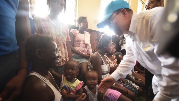 UN Secretary-General Ban Ki-moon greets victims of the Hurricane Matthew at a shelter in the Lycee Phillipe Guerrier in the city of Les Cayes, in the southwest of Haiti, on October 15, 2016. - Sputnik International