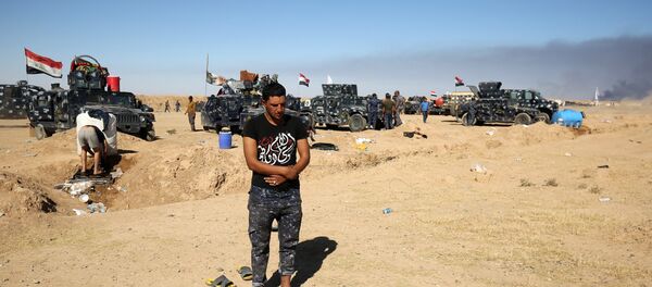 A Sunni Iraqi policeman prays at the Qayyarah military base, about 60 kilometres (35 miles) south of Mosul, on October 16, 2016, as they prepare for an offensive to retake Mosul. A Sunni Iraqi policeman prays at the Qayyarah military base, about 60 kilometres (35 miles) south of Mosul, on October 16, 2016, as they prepare for an offensive to retake Mosul. - Sputnik International