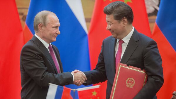 Russian President Vladimir Putin, left, and President of the People's Republic of China Xi Jinping during a signing ceremony of documents following their talks in Beijing - Sputnik International