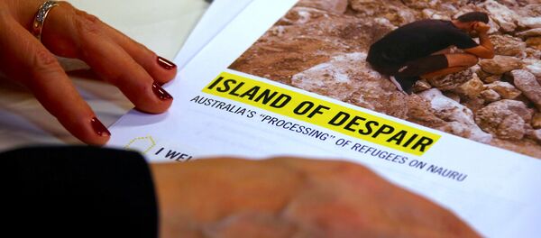 Anna Neistat, Senior Director for Research with Amnesty International, talks to journalists as she holds a copy of a report she co-authored titled 'Island of Despair - Australia's Processing of Refugees on Nauru' in Sydney, Australia, October 17, 2016 - Sputnik International