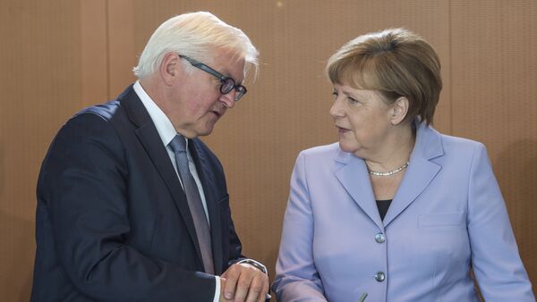 German Chancellor Angela Merkel (R) chats with German Foreign Minister Frank-Walter Steinmeier as she arrives for a weekly meeting of the German cabinet at the chancellery in Berlin on May 11, 2016 - Sputnik International