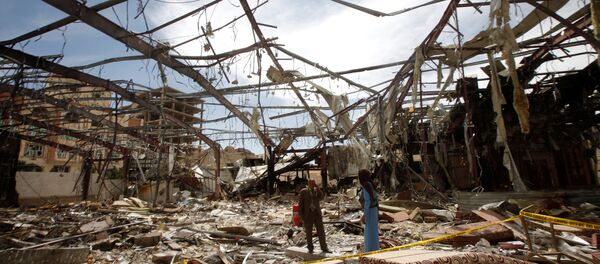 Member of the Specialized Criminal Prosecution Rajeh Zayed (L) responds to a call during a visit by human rights activists to a community hall that was struck by an air strike during a funeral on October 8, in Sanaa, Yemen, October 16, 2016 Member of the Specialized Criminal Prosecution Rajeh Zayed (L) responds to a call during a visit by human rights activists to a community hall that was struck by an air strike during a funeral on October 8, in Sanaa, Yemen, October 16, 2016 - Sputnik International