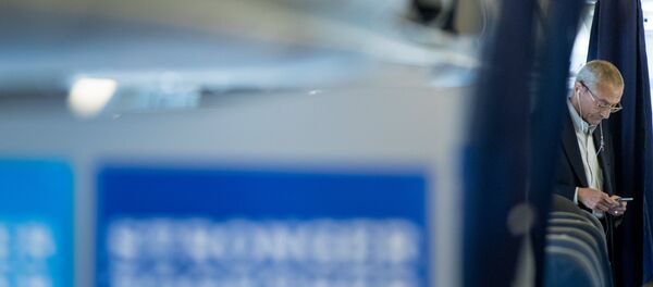 Clinton campaign manager John Podesta looks at a smartphone while aboard a plane at Westchester County Airport in White Plains, N.Y., Tuesday, Oct. 11, 2016, before traveling to Miami Clinton campaign manager John Podesta looks at a smartphone while aboard a plane at Westchester County Airport in White Plains, N.Y., Tuesday, Oct. 11, 2016, before traveling to Miami - Sputnik International