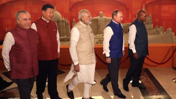 Leaders of BRICS nations, from left, Brazilian President Michel Temer, Chinese President Xi Jinping, Indian Prime Minister Narendra Modi, Russian President Vladimir Putin and South African President Jacob Zuma walk past sand sculptures of famous landmarks of BRICS nations created by Indian sand artist Sudarsan Pattnaik, prior to dinner hosted by Modi in Goa, India, Saturday, Oct. 15, 2016 - Sputnik International