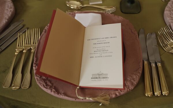 A table is set with gold silverware and a menu during a preview in advance of the State Dinner in honor of the Official Visit of Italian Prime Minister Matteo Renzi and his wife Agnese Landini, Monday, Oct. 17, 2016, in the State Dining Room of the White House in Washington - Sputnik International
