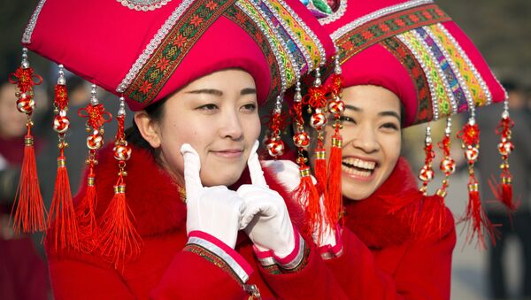 Hostesses pose for photos outside the Great Hall of the People during the opening session of the annual National People's Congress in Beijing - Sputnik International
