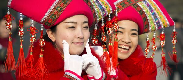 Hostesses pose for photos outside the Great Hall of the People during the opening session of the annual National People's Congress in Beijing Hostesses pose for photos outside the Great Hall of the People during the opening session of the annual National People's Congress in Beijing - Sputnik International