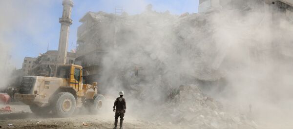 A Civil Defence member stands as a front loader removes debris after an air strike Sunday in the rebel-held besieged al-Qaterji neighbourhood of Aleppo, Syria October 17, 2016. A Civil Defence member stands as a front loader removes debris after an air strike Sunday in the rebel-held besieged al-Qaterji neighbourhood of Aleppo, Syria October 17, 2016. - Sputnik International