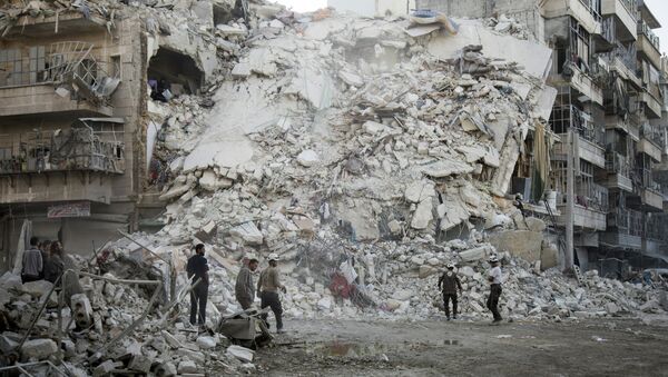 Members of the Syrian Civil Defence, known as the White Helmets, search for victims amid the rubble of a destroyed building following reported air strikes in the rebel-held Qatarji neighbourhood of the northern city of Aleppo, on October 17, 2016. - Sputnik International
