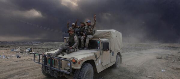 Iraqi army personnel ride on a military vehicle in Qayyarah, during an operation to attack Islamic State militants in Mosul, Iraq - Sputnik International