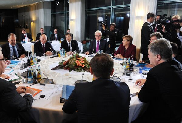 Russian President Vladimir Putin, German Chancellor Angela Merkel, background 2nd right, and Ukrainian President Petro Poroshenko, foreground right, during the Normandy format meeting between the leaders of Germany, Russia, Ukraine and France on settling the Ukrainian conflict, at the Paul Loebe Haus parliamentary building in Berlin. (File) Russian President Vladimir Putin, German Chancellor Angela Merkel, background 2nd right, and Ukrainian President Petro Poroshenko, foreground right, during the Normandy format meeting between the leaders of Germany, Russia, Ukraine and France on settling the Ukrainian conflict, at the Paul Loebe Haus parliamentary building in Berlin. (File) - Sputnik International