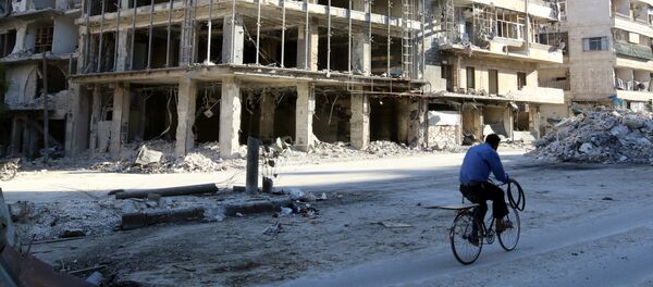 A man rides a bicycle near damaged buildings in the rebel held besieged al-Sukkari neighbourhood of Aleppo, Syria October 19, 2016. A man rides a bicycle near damaged buildings in the rebel held besieged al-Sukkari neighbourhood of Aleppo, Syria October 19, 2016. - Sputnik International