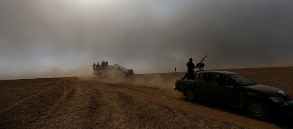 Members of the Iraqi security forces ride on military vehicles after the liberation of Khalidiya village from Islamic State militants south of Mosul, during an operation to attack Islamic State militants in Mosul, Iraq, October 20, 2016. - Sputnik International