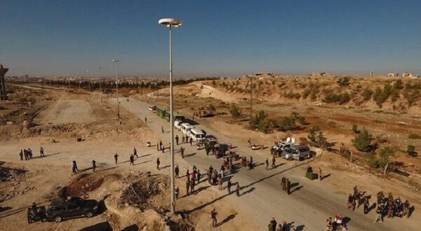 Law enforcement officers near cars and ambulances in a humanitarian corridor for civilians and militants along the Castello Road in northern Aleppo, Syria Law enforcement officers near cars and ambulances in a humanitarian corridor for civilians and militants along the Castello Road in northern Aleppo, Syria - Sputnik International