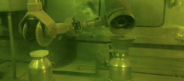 Operator putting plutonium dioxide powder in a container for storage and processing using handler. Operator putting plutonium dioxide powder in a container for storage and processing using handler. - Sputnik International