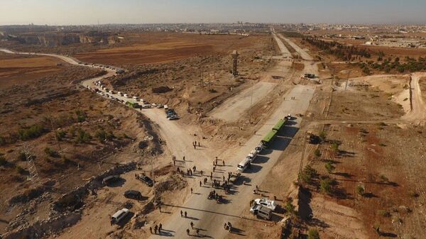 Law enforcement officers near cars and ambulances in a humanitarian corridor along the Castello Road in northern Aleppo, Syria Law enforcement officers near cars and ambulances in a humanitarian corridor along the Castello Road in northern Aleppo, Syria - Sputnik International