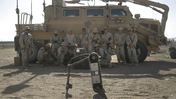 US Marines from the 2nd Marine Expeditionary Brigade are taught how to use a robot to search for improvised explosive devices during training lesson at Camp Leatherneck in Afghanistan's Helmand province Tuesday June 9, 2009. - Sputnik International