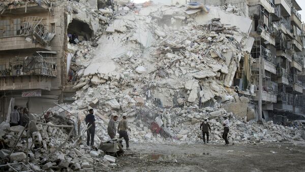 Members of the Syrian Civil Defence, known as the White Helmets, search for victims amid the rubble of a destroyed building following reported air strikes in the rebel-held Qatarji neighbourhood of the northern city of Aleppo, on October 17, 2016 - Sputnik International
