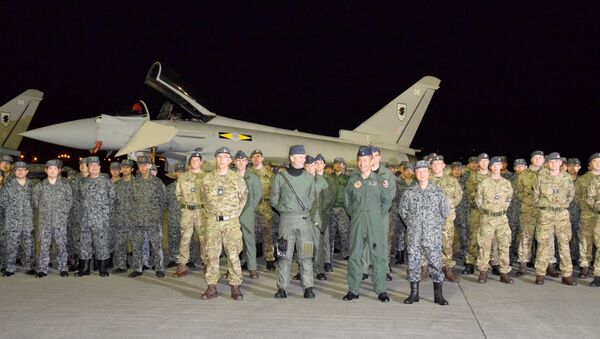 British Royal Air Force's soldiers pose with Japan Air Self-Defense Force soldiers for a photograph in front of a Typhoon Eurofighter jet upon their arrival to participate in a joint military drill with Japan's air force, at Misawa air base in Misawa, Aomori prefecture, Japan, in this photo taken by Kyodo October 22, 2016 - Sputnik International