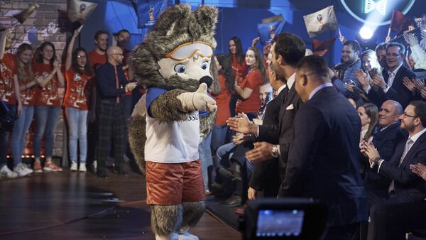 FIFA 2018 World Cup Russia official mascot, the wolf named Zabivaka, center, shakes hands with Vitaly Mutko, deputy premiership in charge of sport, tourism and youth policies, Alexey Sorokin, CEO of the 2018 FIFA World Cup Russia Local Organizing Committee, all back to a camera, during a TV show on Russian Channel 1 in Moscow, Russia, Saturday, Oct. 22, 2016 - Sputnik International