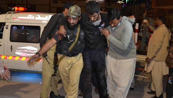 A Pakistani volunteer and a police officer rush an injured person to a hospital in Quetta, Pakistan, Monday, Oct. 24, 2016, after two separate attacks in Pakistan - Sputnik International