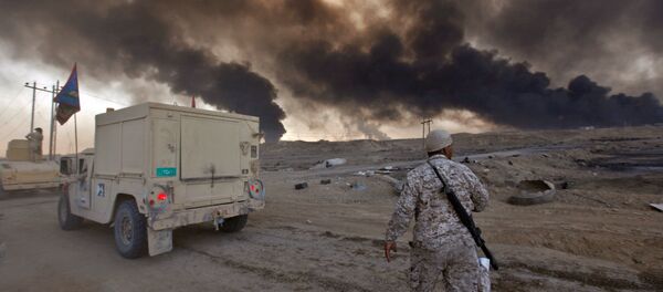 Iraqi army are seen in Qayyara, Iraq, October 22, 2016. The fumes in the background are from oil wells that were set ablaze by Islamic State militants Iraqi army are seen in Qayyara, Iraq, October 22, 2016. The fumes in the background are from oil wells that were set ablaze by Islamic State militants - Sputnik International