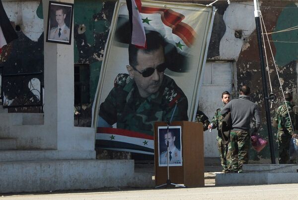 Banners with the portrait of Syrian President Bashar al-Assad at a self-defense fighters' training center near Damascus Banners with the portrait of Syrian President Bashar al-Assad at a self-defense fighters' training center near Damascus - Sputnik International