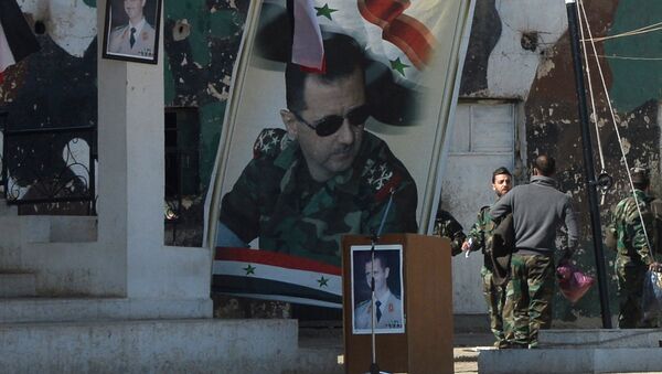 Banners with the portrait of Syrian President Bashar al-Assad at a self-defense fighters' training center near Damascus - Sputnik International