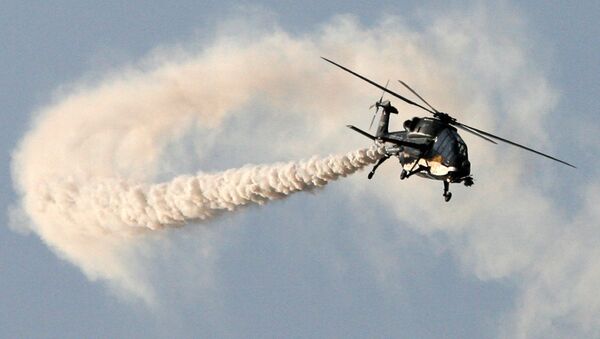 This handout photograph released by the Ministry of Defence on February 20, 2013, shows a HAL Black Tiger Light Combat Helicopter (LCH) performing a flypast during a full dress rehearsal for the Indian Air Force's Iron Fist 2013 military exercicse in Pokhran, near Jaisalmer in India's Rajasthan state, on February 19, 2013 - Sputnik International