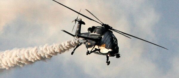 This handout photograph released by the Ministry of Defence on February 20, 2013, shows a HAL Black Tiger Light Combat Helicopter (LCH) performing a flypast during a full dress rehearsal for the Indian Air Force's Iron Fist 2013 military exercicse in Pokhran, near Jaisalmer in India's Rajasthan state, on February 19, 2013 - Sputnik International