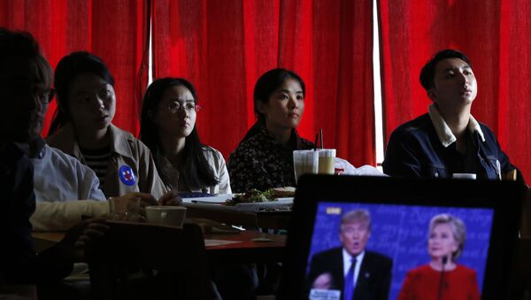Chinese students watch live broadcasting of the U.S. presidential debate between Democratic presidential nominee Hillary Clinton and Republican presidential nominee Donald Trump, at a cafe in Beijing, Tuesday, Sept. 27, 2016 - Sputnik International