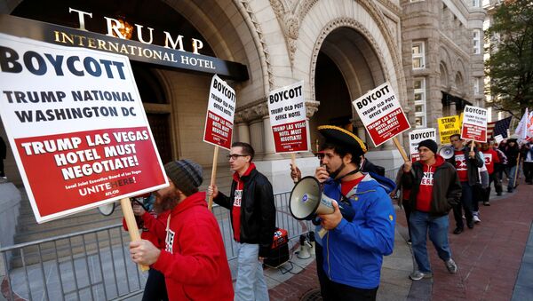 Representative of the AFL-CIO labor union protest against Republican U.S. presidential nominee Donald Trump on the sidewalk outside of the grand opening of his new Trump International Hotel in Washington, U.S. October 26, 2016 - Sputnik International