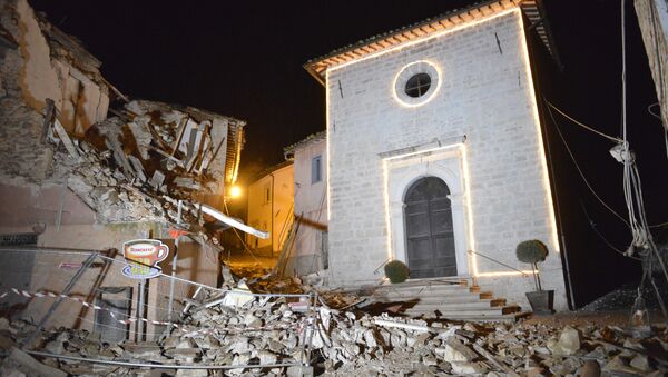 The Church of San Sebastiano stands amidst damaged houses in Castelsantangelo sul Nera, Italy, Wednesday, Oct 26, 2016 following an earthquake,. - Sputnik International