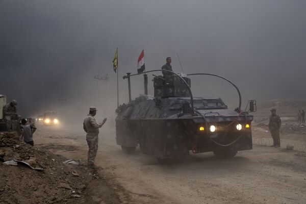An Iraqi Federal Police vehicle passes through a checkpoint in Qayara, some 50 kilometers south of Mosul, Iraq, Wednesday, Oct. 26, 2016. An Iraqi Federal Police vehicle passes through a checkpoint in Qayara, some 50 kilometers south of Mosul, Iraq, Wednesday, Oct. 26, 2016. - Sputnik International