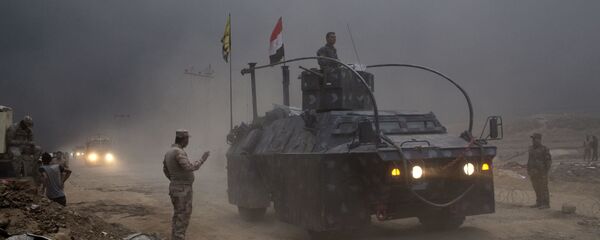 An Iraqi Federal Police vehicle passes through a checkpoint in Qayara, some 50 kilometers south of Mosul, Iraq, Wednesday, Oct. 26, 2016. An Iraqi Federal Police vehicle passes through a checkpoint in Qayara, some 50 kilometers south of Mosul, Iraq, Wednesday, Oct. 26, 2016. - Sputnik International