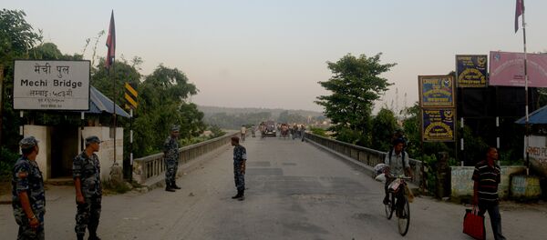 Nepalese security personnel stand guard at an entry point to Nepal from India at Mechinagar on the eastern Nepalese border with India. (File) Nepalese security personnel stand guard at an entry point to Nepal from India at Mechinagar on the eastern Nepalese border with India. (File) - Sputnik International