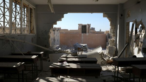 A damaged classroom is pictured after shelling in the rebel held town of Hass, south of Idlib province, Syria - Sputnik International