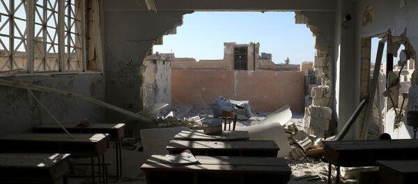 A damaged classroom is pictured after shelling in the rebel held town of Hass, south of Idlib province, Syria - Sputnik International