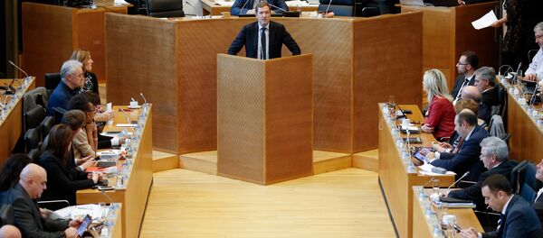 Members of the Wallon parliament listen as Walloon Minister-President Paul Magnette (C) speaks at a plenary session during a debate on the CETA (EU-Canada Comprehensive Economic and Trade Agreement) in Namur Members of the Wallon parliament listen as Walloon Minister-President Paul Magnette (C) speaks at a plenary session during a debate on the CETA (EU-Canada Comprehensive Economic and Trade Agreement) in Namur - Sputnik International
